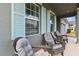Inviting front porch with comfortable seating and light blue shutters at 410 Winter Bliss Ln, Mount Dora, FL 32757