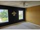 A room with black and yellow walls, decorated with a Fleur de Lis and a ceiling fan at 438 Janice Kay Pl, Kissimmee, FL 34744