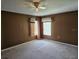 Bedroom with two windows, ceiling fan, and carpet at 438 Janice Kay Pl, Kissimmee, FL 34744