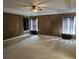 Bedroom with a ceiling fan, tray ceiling, and three windows at 438 Janice Kay Pl, Kissimmee, FL 34744
