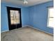 Empty bedroom with blue walls, carpet flooring and two windows dressed with curtains at 438 Janice Kay Pl, Kissimmee, FL 34744