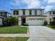 Inviting two-story home featuring a classic design and well-maintained front yard at 438 Janice Kay Pl, Kissimmee, FL 34744