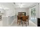A view of the dining room featuring a hardwood table and sliding glass doors to the back patio at 4825 Loretta Ln, Orlando, FL 32821