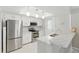 Bright kitchen features stainless steel appliances, white cabinets, and modern countertops for a sleek cooking space at 4825 Loretta Ln, Orlando, FL 32821
