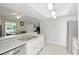 Open kitchen overlooking dining area, featuring stainless steel appliances, a breakfast bar, and plenty of natural light at 4825 Loretta Ln, Orlando, FL 32821