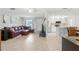 Open-concept living space showcasing a kitchen, living room, and dining area with tile floors at 4825 Loretta Ln, Orlando, FL 32821