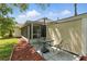 Outdoor patio with table and chairs for relaxing, next to the screened-in porch at 4825 Loretta Ln, Orlando, FL 32821