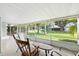 Cozy screened porch with outdoor seating offering views of the landscaped backyard at 4825 Loretta Ln, Orlando, FL 32821