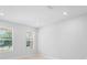 Bright bedroom with neutral walls and tile flooring, complemented by windows offering natural light at 5030 Caspian St, St Cloud, FL 34771