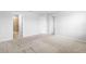 Large bedroom with carpet flooring and two doorways, one leading to the bathroom at 5030 Caspian St, St Cloud, FL 34771