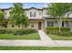 Charming two-story townhome with manicured landscaping, healthy plants, and a welcoming walkway at 5030 Caspian St, St Cloud, FL 34771