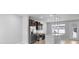 Modern kitchen with stainless steel appliances, dark cabinets, granite countertops, and pendant lighting at 5030 Caspian St, St Cloud, FL 34771