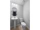 Clean powder room with a pedestal sink, oval mirror, and a toilet at 5030 Caspian St, St Cloud, FL 34771