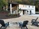 A backyard features an outdoor fire pit and seating area for entertaining with a spacious gravel area at 610 Cypress Ave, Orange City, FL 32763