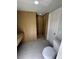 A bathroom features a wood-lined walk-in shower with tiled floors, a bench and a modern toilet at 610 Cypress Ave, Orange City, FL 32763