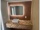 A modern bathroom with a wood-look cabinet, a sink and an illuminated mirror at 610 Cypress Ave, Orange City, FL 32763