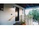 This is a view of the home exterior with a modern accent wall and a black door at 610 Cypress Ave, Orange City, FL 32763