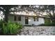 Exterior daytime view of a single-story home with dark shutters and a pea gravel yard at 610 Cypress Ave, Orange City, FL 32763