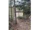 Secure gated entrance with a newly constructed wooden fence, enhancing privacy and security at 610 Cypress Ave, Orange City, FL 32763