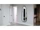 Hallway featuring modern decor including a full length mirror and access to other rooms at 610 Cypress Ave, Orange City, FL 32763
