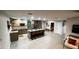 Open-concept kitchen with granite island, stainless steel appliances, and skylight at 610 Cypress Ave, Orange City, FL 32763