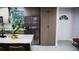 Well-lit kitchen with a stainless steel refrigerator and wood cabinetry at 610 Cypress Ave, Orange City, FL 32763