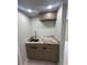 The laundry room includes a sink, granite countertop and custom wood cabinets at 610 Cypress Ave, Orange City, FL 32763