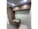 This laundry room has a granite countertop, sink and custom wood cabinets at 610 Cypress Ave, Orange City, FL 32763