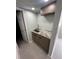 The well-lit laundry room features a granite countertop, sink and custom cabinets at 610 Cypress Ave, Orange City, FL 32763