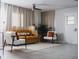 Cozy living room with a gold couch, accent chairs, indoor plants, and a neutral rug and curtain at 610 Cypress Ave, Orange City, FL 32763