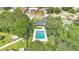 An aerial perspective reveals a home with a well-maintained lawn, backyard pool, and mature trees in a tranquil setting at 614 Mockingbird Ln, Altamonte Springs, FL 32714