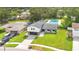 An inviting Gathering home boasting a pristine lawn and refreshing pool, complemented by mature trees and a welcoming exterior at 614 Mockingbird Ln, Altamonte Springs, FL 32714