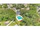 A home with a private pool and lush greenery, nestled in a quiet neighborhood shaded by mature trees at 614 Mockingbird Ln, Altamonte Springs, FL 32714