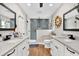 Beautiful bathroom features dual vanities, modern fixtures, and a glass enclosed walk-in shower at 614 Mockingbird Ln, Altamonte Springs, FL 32714