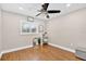 Bright bedroom with hardwood floors, a ceiling fan, and a window for natural light at 614 Mockingbird Ln, Altamonte Springs, FL 32714