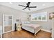Cozy bedroom with a white bed frame, wood floors, and a bright window with shutters at 614 Mockingbird Ln, Altamonte Springs, FL 32714