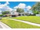 Charming two-story home with a brick and gray two-car garage and beautifully manicured lawn at 614 Mockingbird Ln, Altamonte Springs, FL 32714