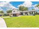 Charming two-story home with a brick and gray two-car garage and beautifully manicured lawn at 614 Mockingbird Ln, Altamonte Springs, FL 32714
