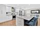 Bright kitchen features an island with barstool seating, stainless appliances and white cabinetry at 614 Mockingbird Ln, Altamonte Springs, FL 32714