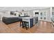 Open kitchen boasts an island with barstool seating, pendant lighting, and backyard views at 614 Mockingbird Ln, Altamonte Springs, FL 32714