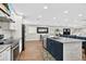 Spacious open floor plan features a large kitchen island, stainless appliances and wood flooring at 614 Mockingbird Ln, Altamonte Springs, FL 32714
