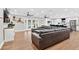 Open concept living room featuring hardwood floors, ceiling fans, large couch, and sliding glass doors to backyard at 614 Mockingbird Ln, Altamonte Springs, FL 32714