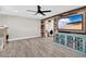 Living room with wood-look flooring, accent wall, entertainment center, and a modern ceiling fan at 614 Mockingbird Ln, Altamonte Springs, FL 32714