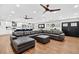 Spacious living room adjacent to kitchen has wood floors, ceiling fans and comfortable seating at 614 Mockingbird Ln, Altamonte Springs, FL 32714