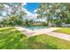 Backyard featuring a private pool surrounded by lush green grass and mature trees at 614 Mockingbird Ln, Altamonte Springs, FL 32714