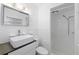 Bathroom featuring white tile, sink, modern fixtures, and walk in shower at 622 Avenue D Se, Winter Haven, FL 33880