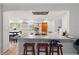 An eat-in kitchen includes bar seating, bright lighting, granite countertops, and stainless appliances at 622 Avenue D Se, Winter Haven, FL 33880