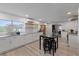 Modern kitchen with white cabinets, granite countertops, stainless steel appliances, and eat-in island at 622 Avenue D Se, Winter Haven, FL 33880
