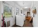 Bright laundry room with washer, dryer, and exterior access at 622 Avenue D Se, Winter Haven, FL 33880