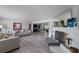 Open-concept living area with a fireplace, hardwood floors, and neutral-toned furnishings at 622 Avenue D Se, Winter Haven, FL 33880
